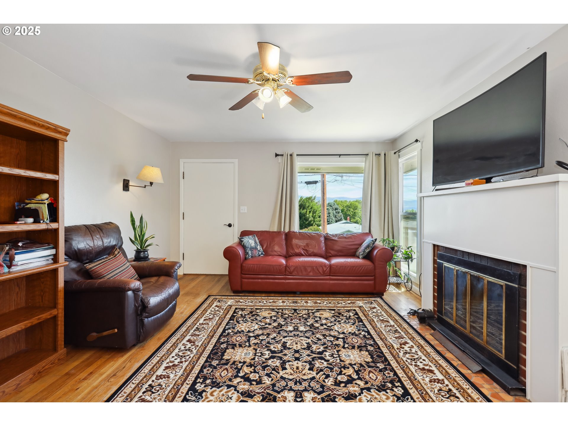 722 East 14th Street The Dalles, OR 97058 - Photo 6 of 43 a living room with furniture a flat screen tv and a fireplace