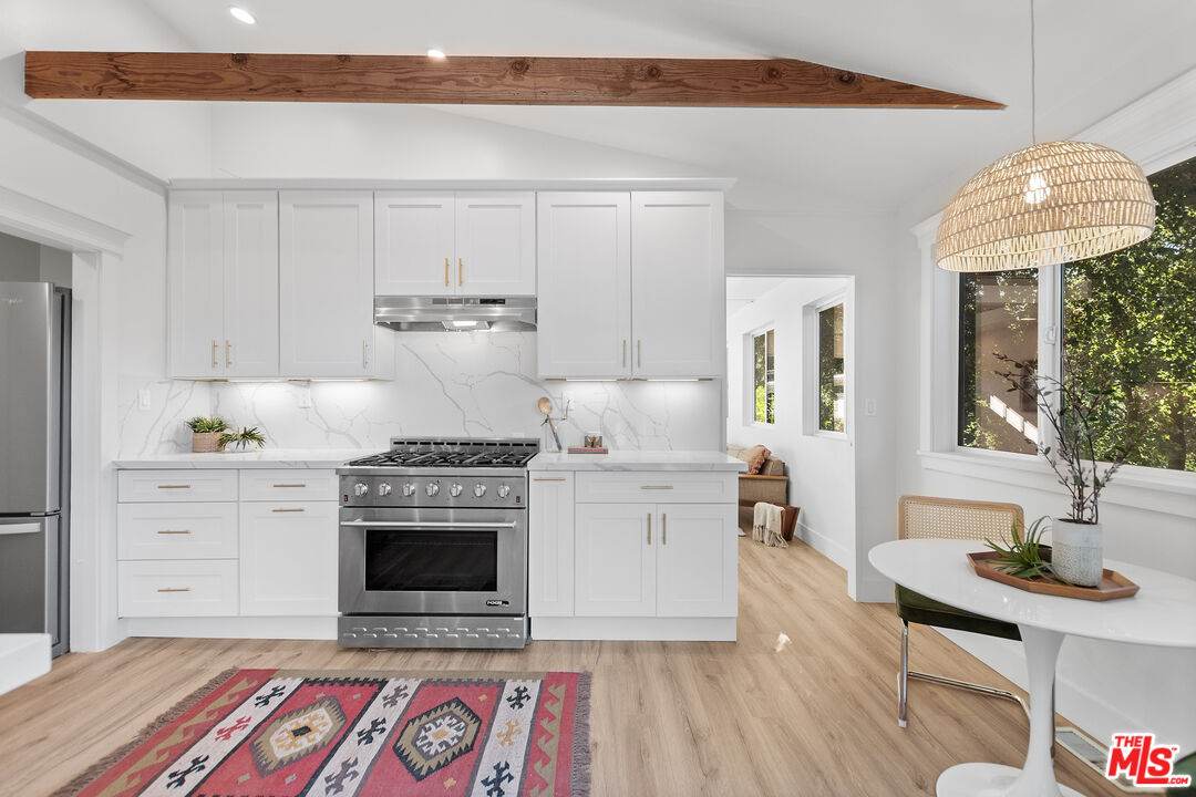 20939 Hillside Drive Topanga, CA 90290 - Photo 13 of 53 a kitchen with a stove and white cabinets
