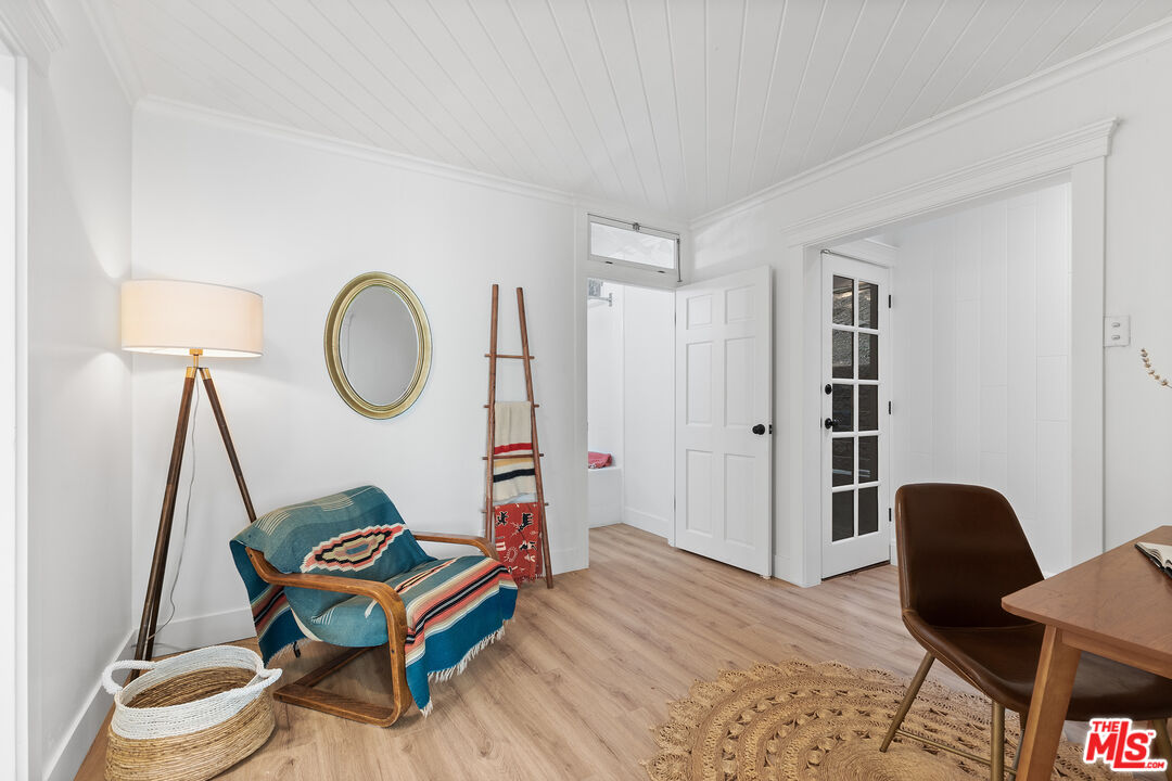 20939 Hillside Drive Topanga, CA 90290 - Photo 15 of 53 a living room with table chairs and a wooden floor