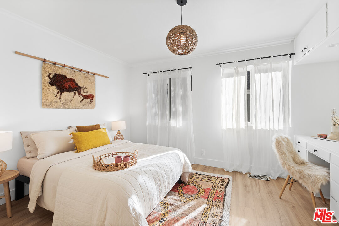 20939 Hillside Drive Topanga, CA 90290 - Photo 17 of 53 a bedroom with a bed and a chandelier