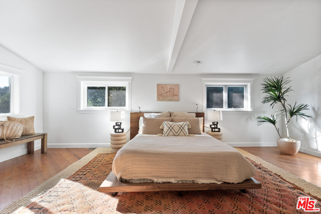 20939 Hillside Drive Topanga, CA 90290 - Photo 22 of 53 a bedroom with a large bed and a couch