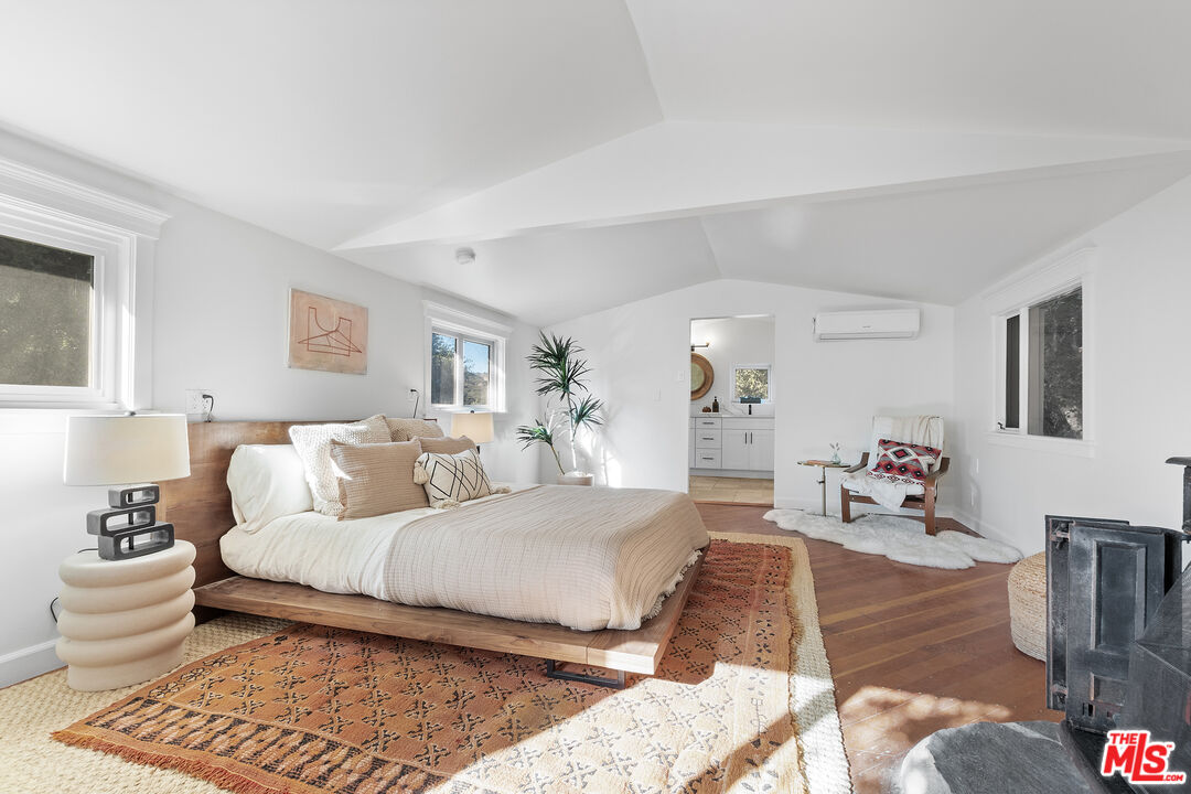 20939 Hillside Drive Topanga, CA 90290 - Photo 24 of 53 a bedroom with a bed and wooden floor