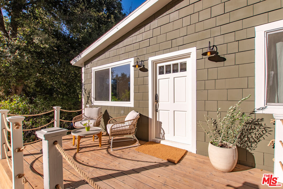 20939 Hillside Drive Topanga, CA 90290 - Photo 29 of 53 a view of a patio with table and chairs and potted plants