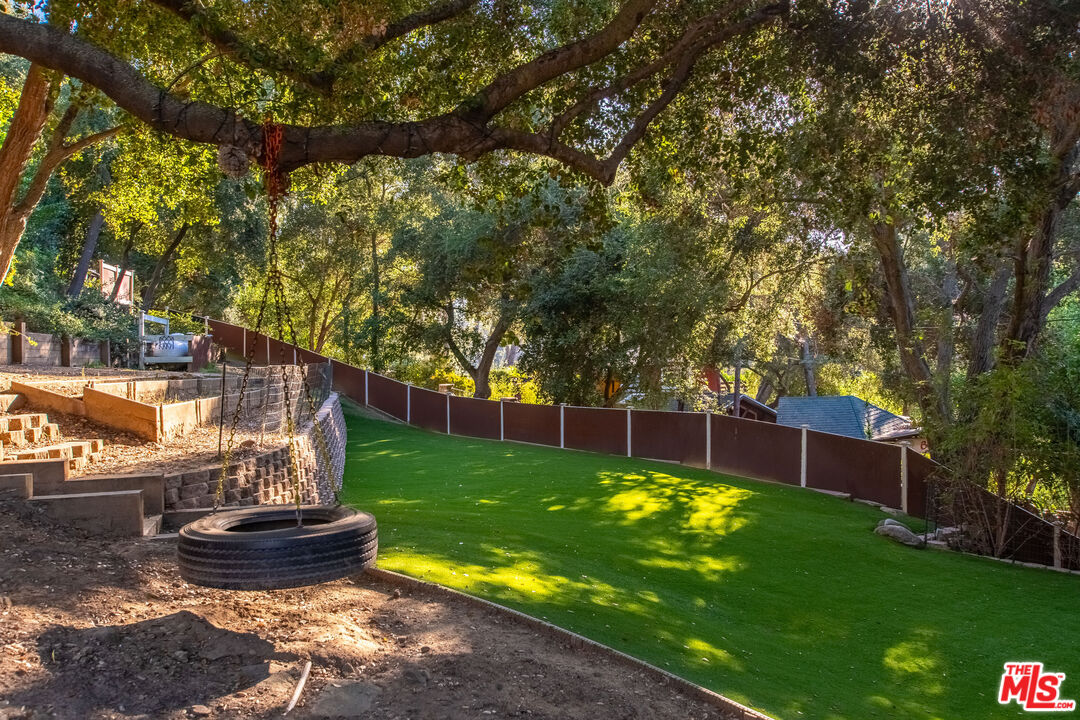 20939 Hillside Drive Topanga, CA 90290 - Photo 47 of 53 a view of a backyard with fountain plants and large trees
