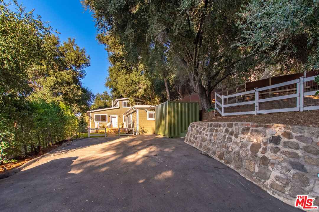20939 Hillside Drive Topanga, CA 90290 - Photo 52 of 53 a front view of a house with a yard and garage