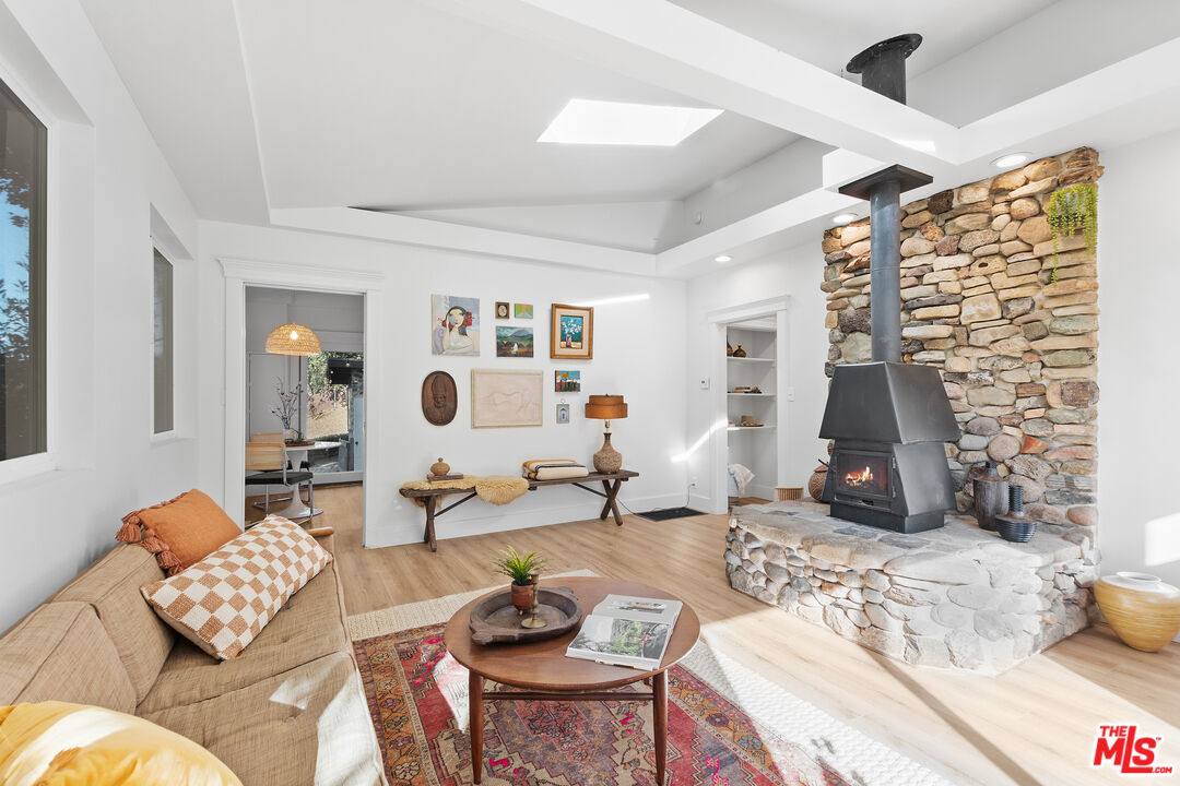 20939 Hillside Drive Topanga, CA 90290 - Photo 7 of 53 a living room with furniture and a flat screen tv