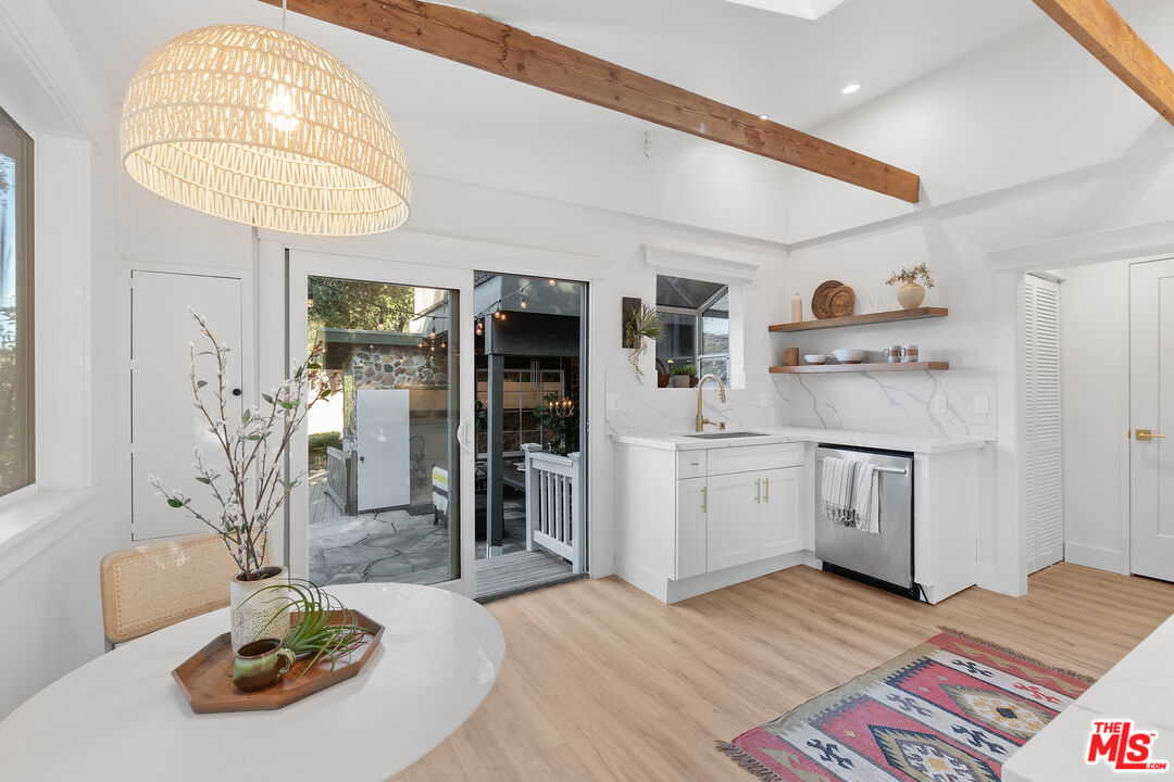 20939 Hillside Drive Topanga, CA 90290 - Photo 8 of 53 a kitchen with stainless steel appliances granite countertop a sink dishwasher and a refrigerator with wooden floor