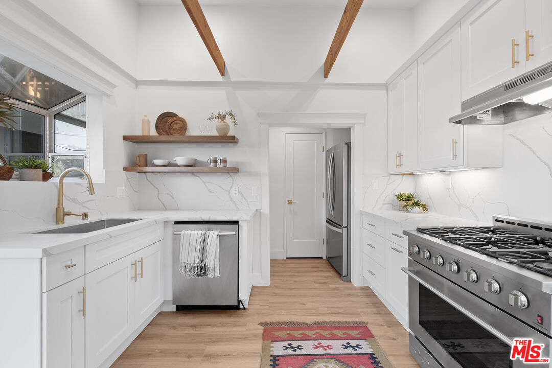20939 Hillside Drive Topanga, CA 90290 - Photo 9 of 53 a kitchen with stainless steel appliances a sink stove and refrigerator