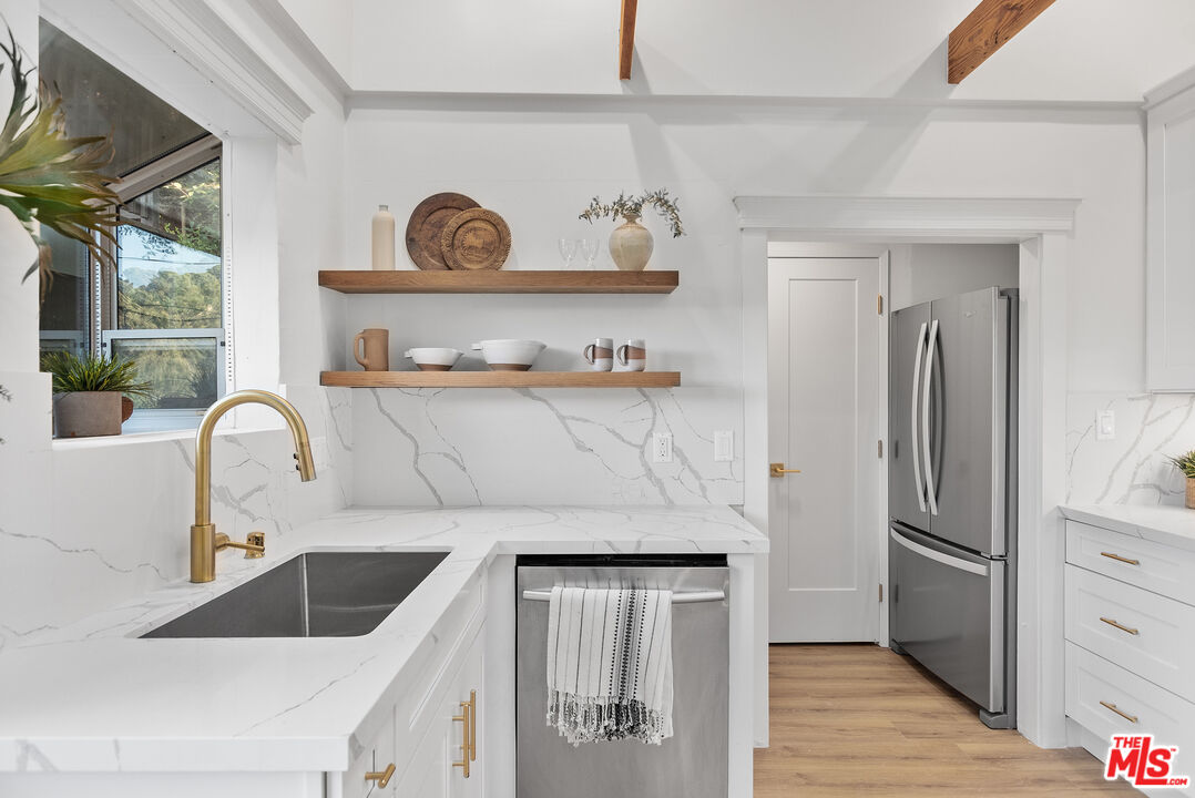 20939 Hillside Drive Topanga, CA 90290 - Photo 10 of 53 a kitchen with a refrigerator and a sink
