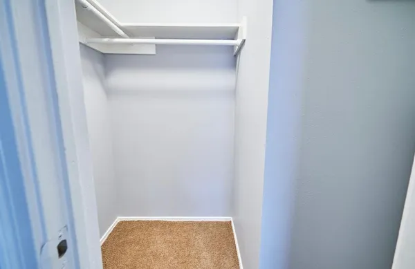 a bathroom with a granite countertop double vanity sink and a mirror