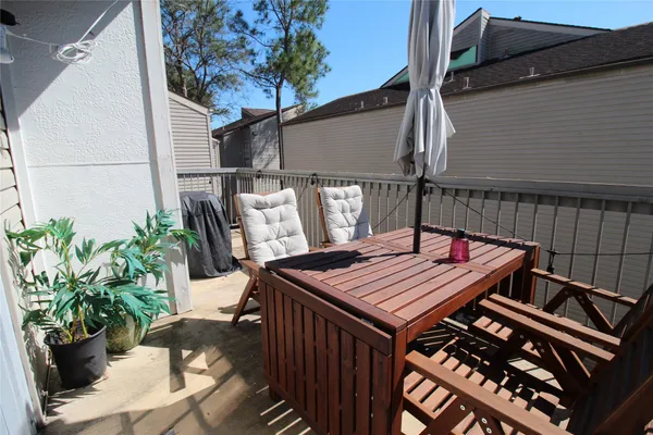 a view of a chairs and tables in the balcony
