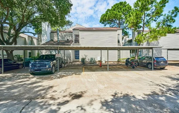 a view of a car parked front of a house