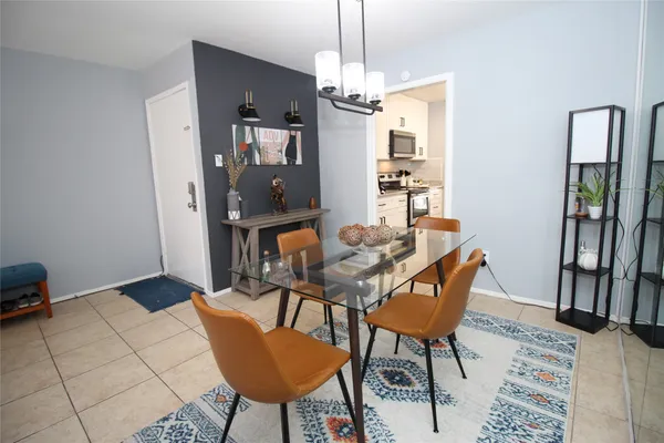 a dining room with furniture and window