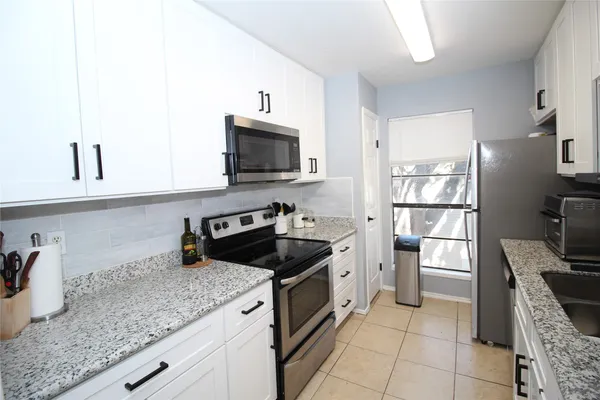 a kitchen with a stove microwave and refrigerator