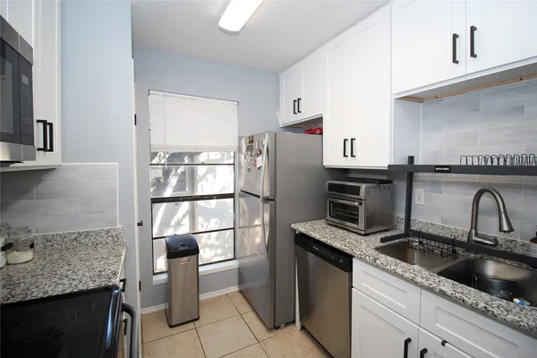 a kitchen with a refrigerator sink and stove