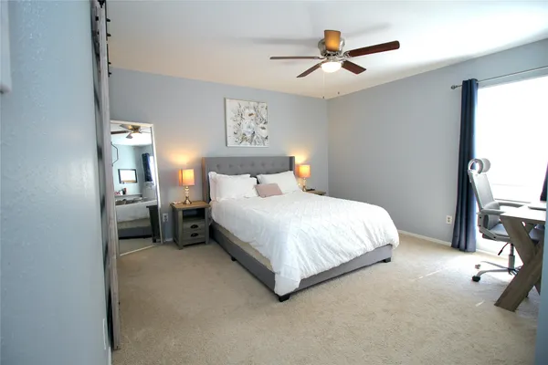 a bedroom with a bed and a chandelier