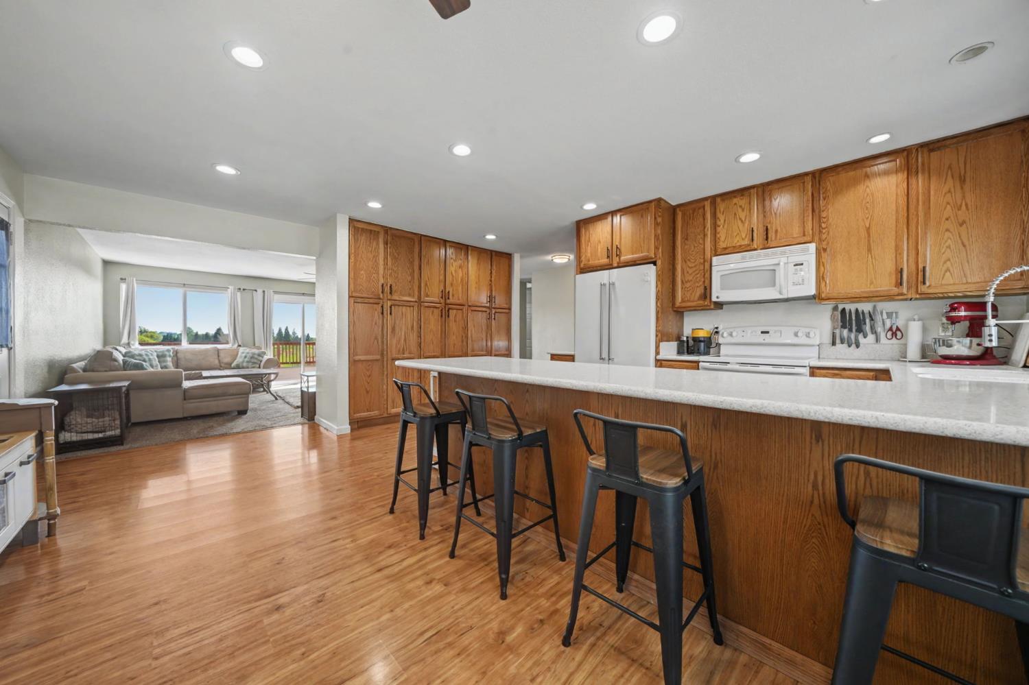 3050 Grapevine Gulch Road Ione, CA 95640 - Photo 1 of 36 a kitchen with stainless steel appliances granite countertop table chairs sink and cabinets