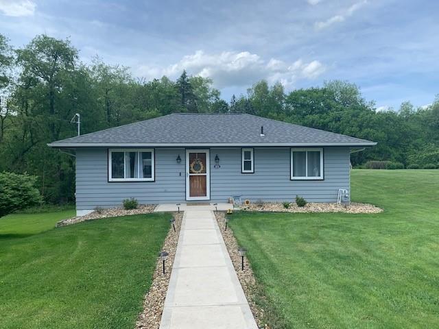 a aerial view of a house next to a big yard and large trees