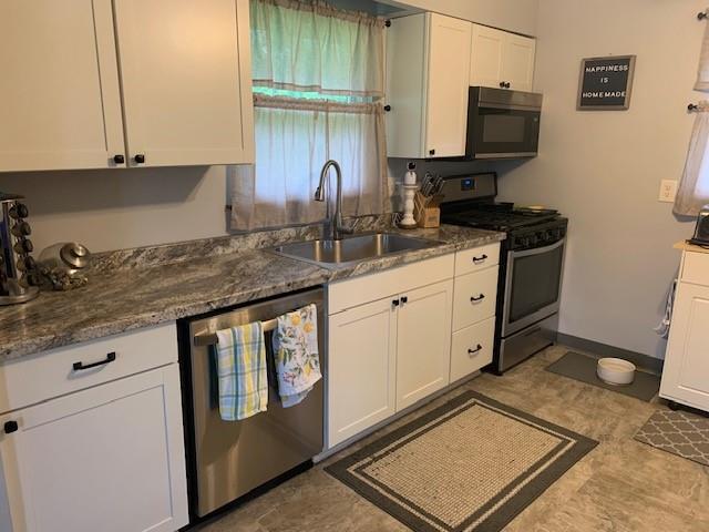 165 Ridge Avenue Freedom, PA 15042 - Photo 3 of 19 a kitchen with stainless steel appliances granite countertop a sink stove and microwave