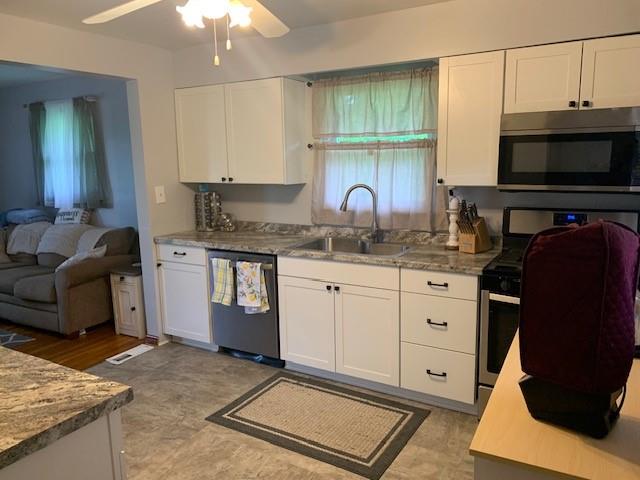 165 Ridge Avenue Freedom, PA 15042 - Photo 4 of 19 a kitchen with a sink stove and cabinets