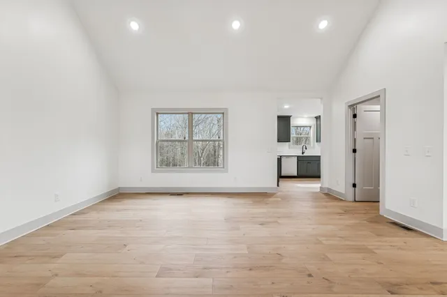 an empty room with windows and entrance