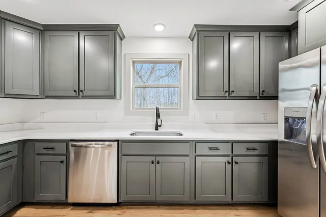 a kitchen with a sink cabinets and stainless steel appliances