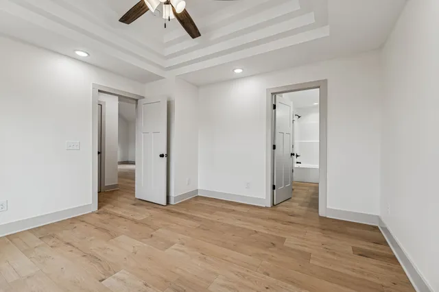 an empty room with fan and entrance