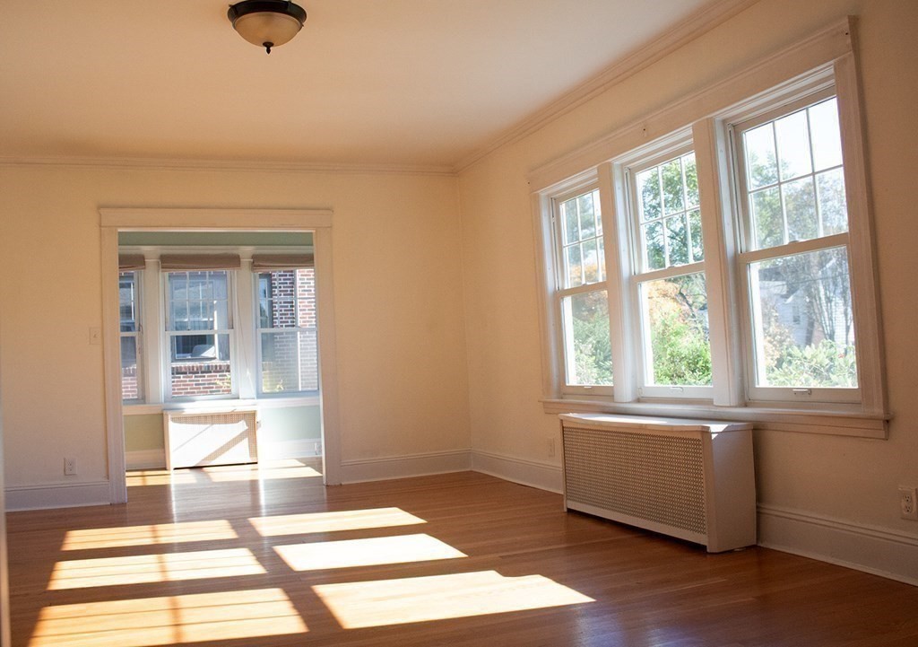 175 June Street Worcester, MA 01602 - Photo 11 of 30 an empty room with wooden floor and windows