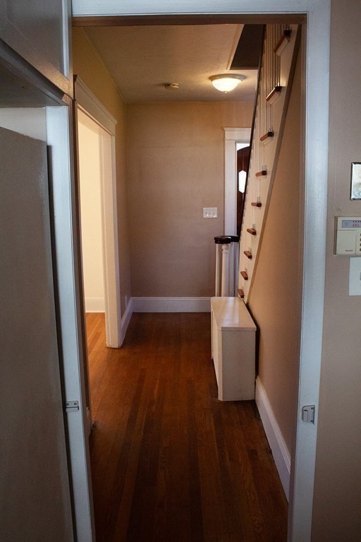 175 June Street Worcester, MA 01602 - Photo 14 of 30 a view of stairs and an empty room with wooden floor