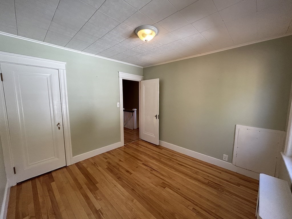 175 June Street Worcester, MA 01602 - Photo 19 of 30 a view of an empty room with wooden floor
