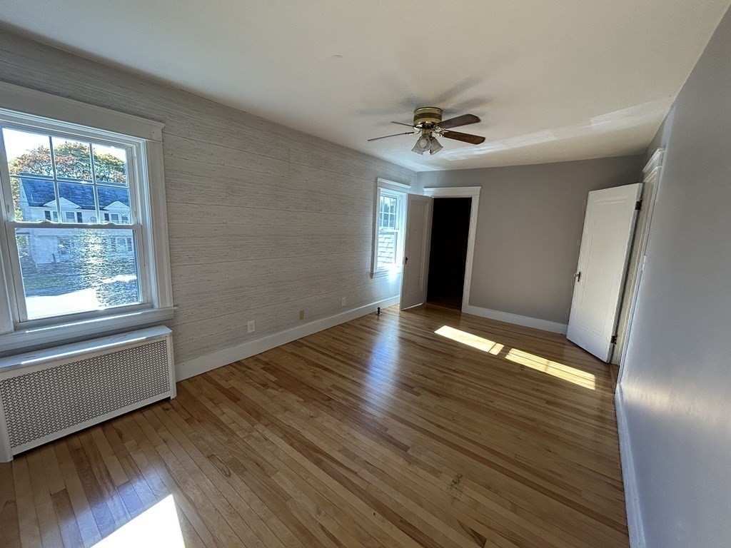 175 June Street Worcester, MA 01602 - Photo 20 of 30 a view of an empty room with wooden floor and a window
