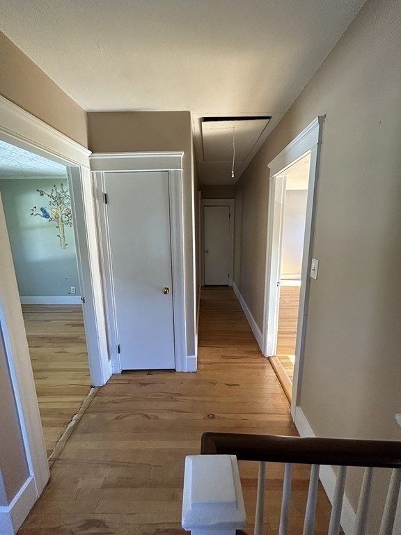 175 June Street Worcester, MA 01602 - Photo 25 of 30 a view of a hallway with wooden floor and staircase
