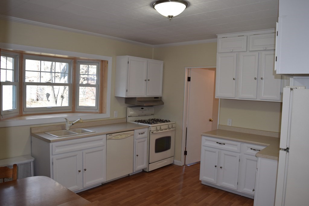 175 June Street Worcester, MA 01602 - Photo 6 of 30 a kitchen with white cabinets appliances and a window