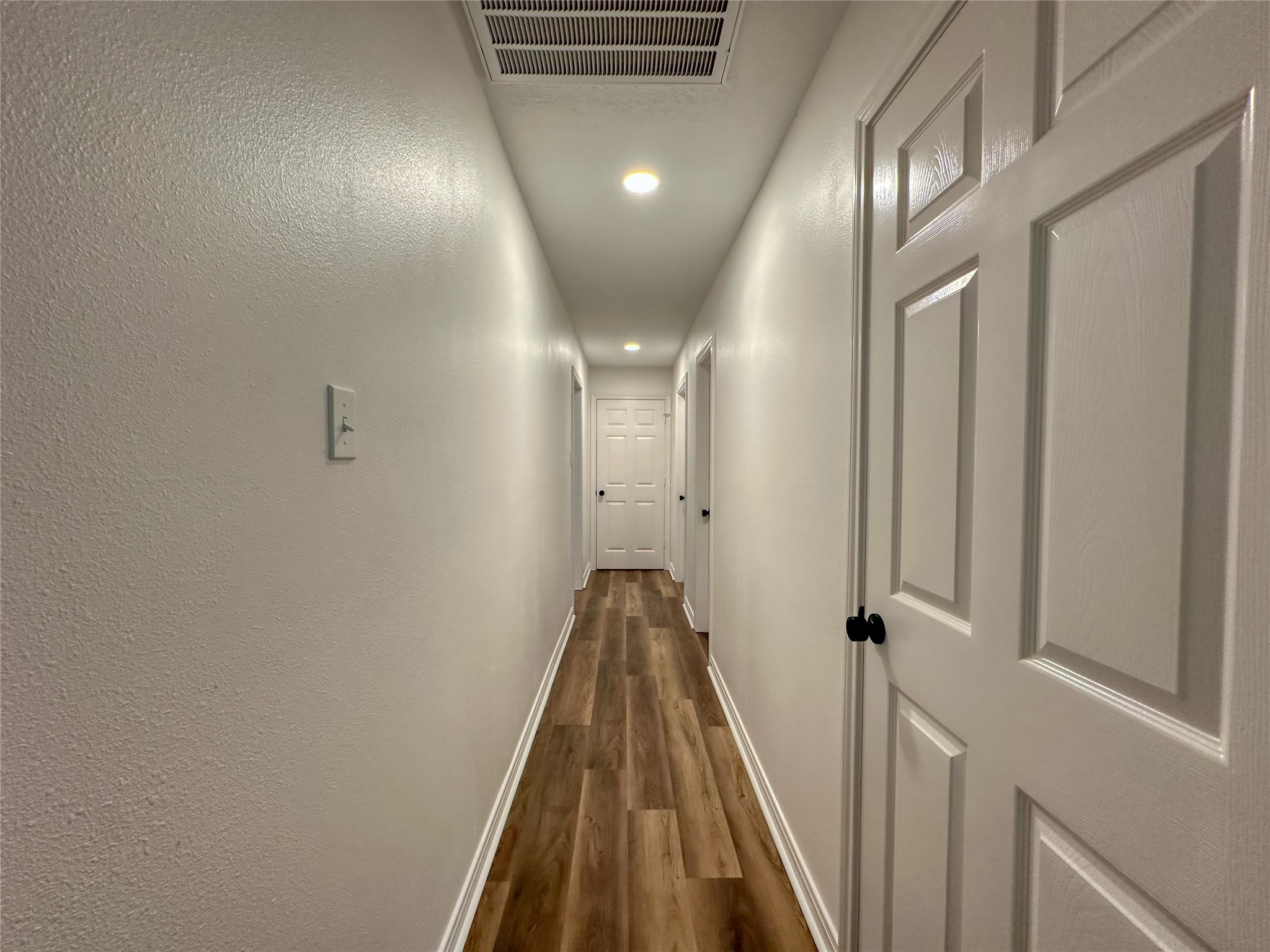 29310 Loddington Street Spring, TX 77386 - Photo 16 of 23 a view of a hallway with wooden floor and staircase
