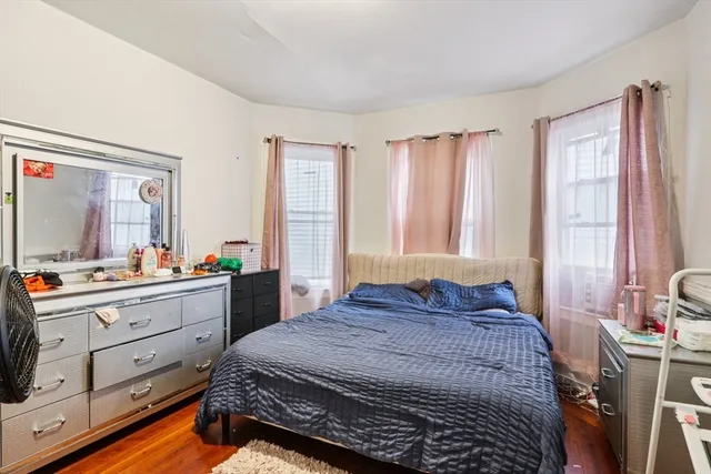 a bedroom with toys and a wooden floor