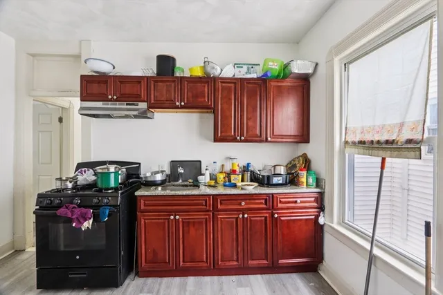 a kitchen with stainless steel appliances a stove and cabinets