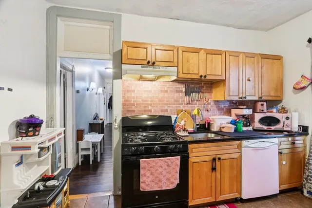 a kitchen with stainless steel appliances granite countertop a stove a sink and a cabinets