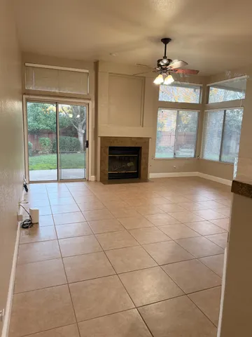 a view of an empty room with a fireplace and a large window