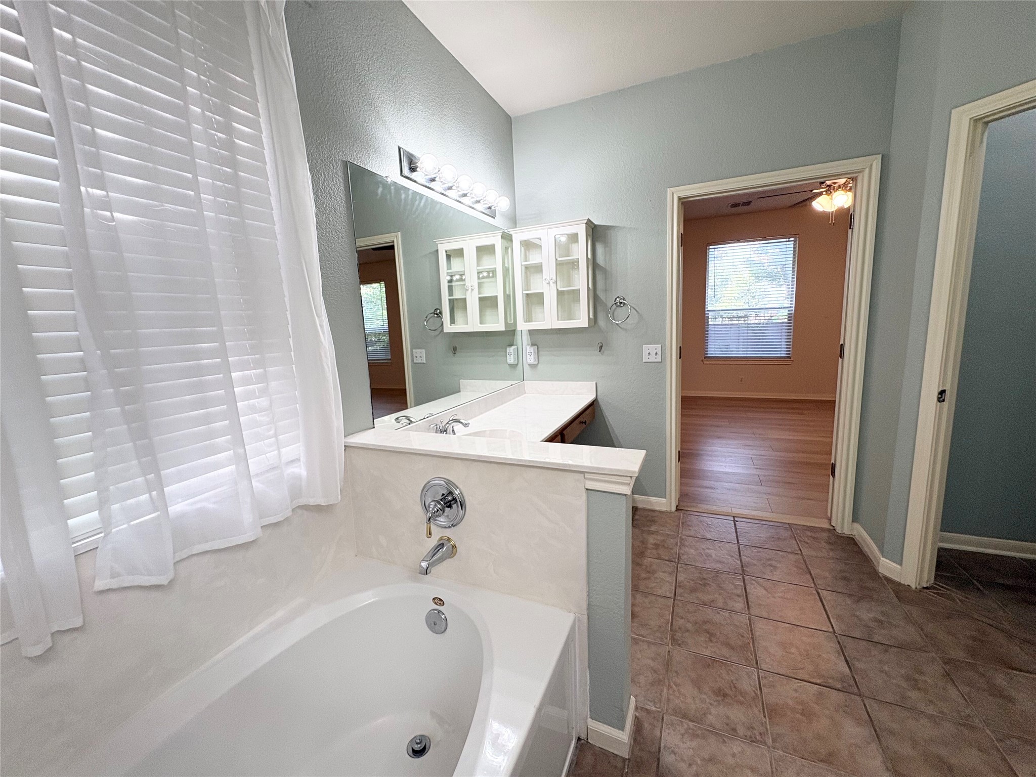 7006 Rambollet Terrace Round Rock, TX 78681 - Photo 19 of 38 A well-appointed bathroom offers a deep soaking tub and a spacious vanity area.