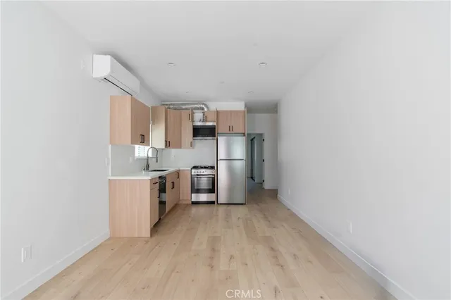 a kitchen with stainless steel appliances a sink and cabinets