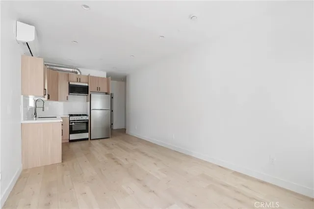 a kitchen with a refrigerator and a stove top oven