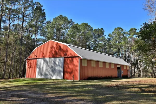 an aerial view of a house with a yard and trees
