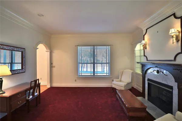 a living room with furniture fireplace and wooden floor