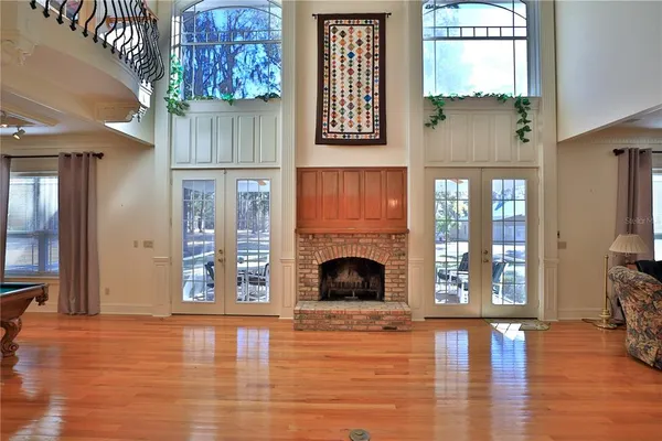 a living room with furniture a fireplace and a chandelier