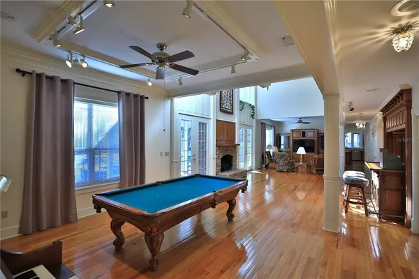 a view of a living room and kitchen with furniture wooden floor and a fireplace