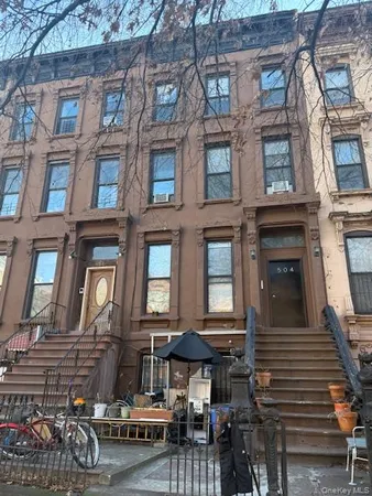 a front view of a brick building with many windows