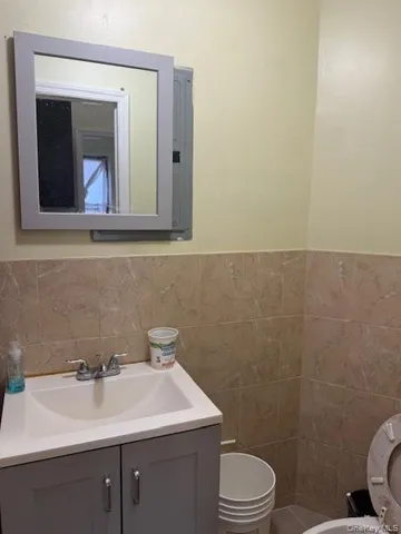 a bathroom with a toilet sink and mirror