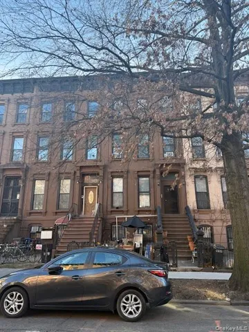 a car parked in front of a brick building