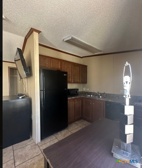 1100 County Road 4600 Dilley, TX 78017 - Photo 4 of 7 a kitchen with a refrigerator and countertop