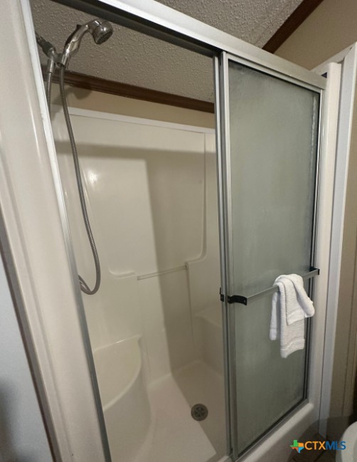 1100 County Road 4600 Dilley, TX 78017 - Photo 7 of 7 a bathroom with a glass shower door